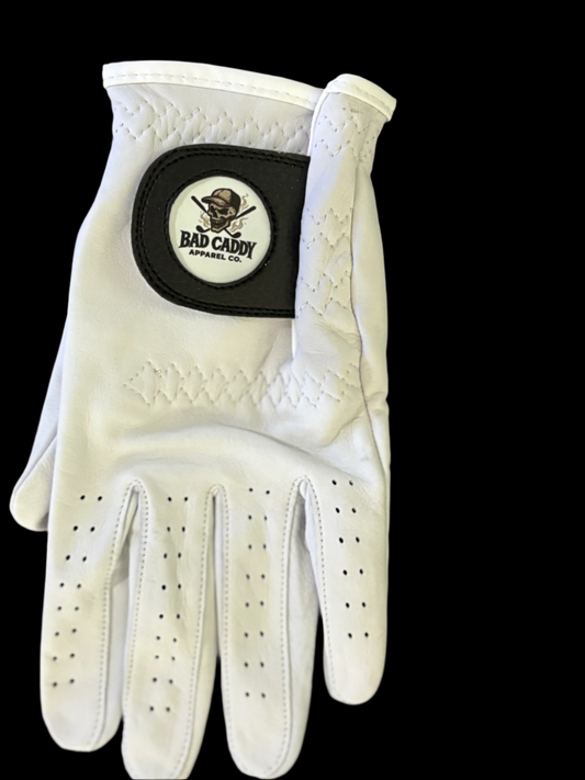 White golf glove with a brand logo on a dark wooden surface